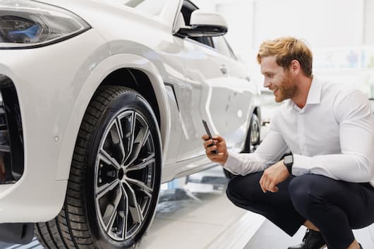 Image of a customer inspecting the exterior of their SUV, purchased at RightRide