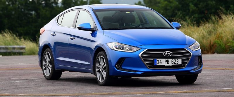 Image of a blue Hyundai Elantra parked outside on the street.