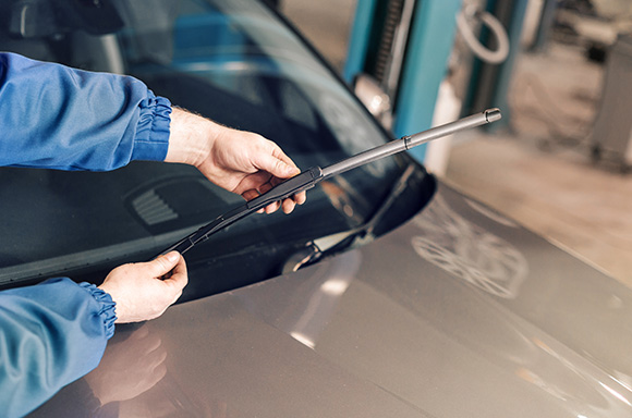 Car owner replacing their own windshield wipers with some new ones.