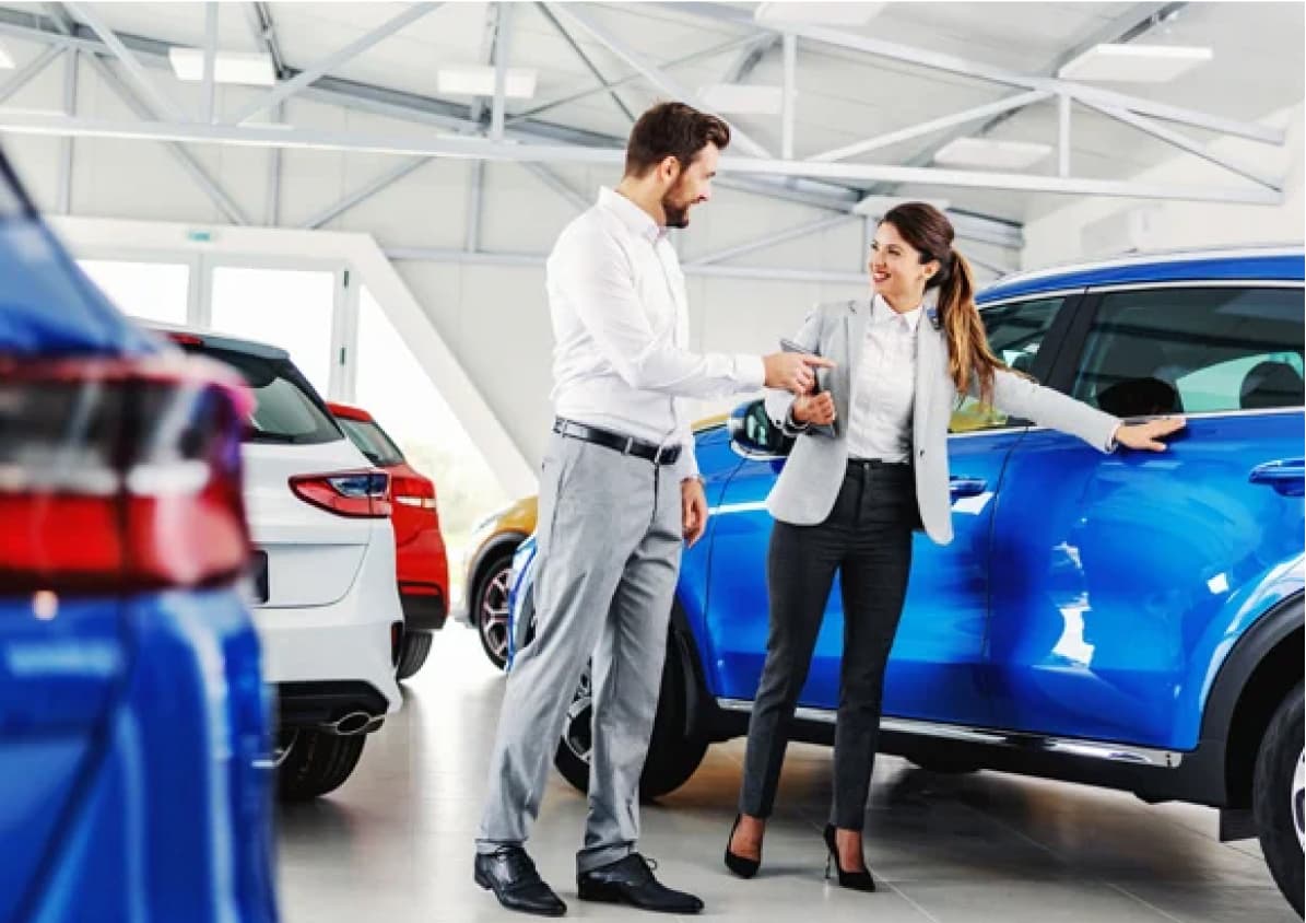 Employee showing a car to a potential buyer.