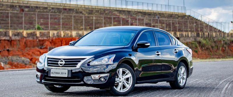 Image of a black Nissan Altima, parked outside on the street.