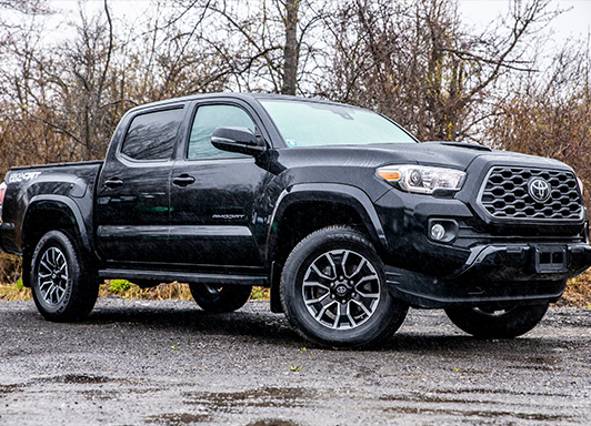 Black Toyota Tacoma Truck, parked outside.