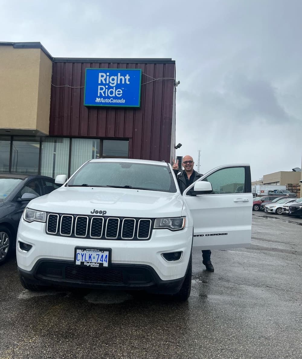 Image of a happy customer, with their brand new vehicle from RightRide.