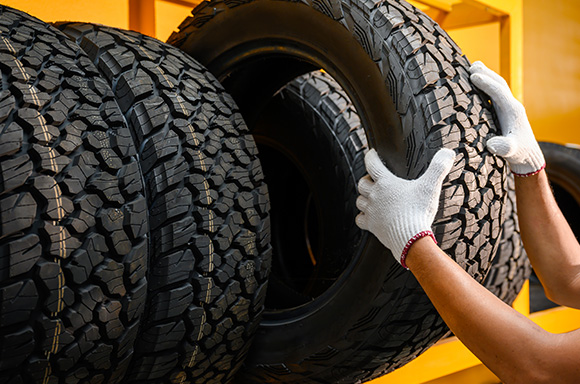 Mechanic swapping out summer tires for winter tires.
