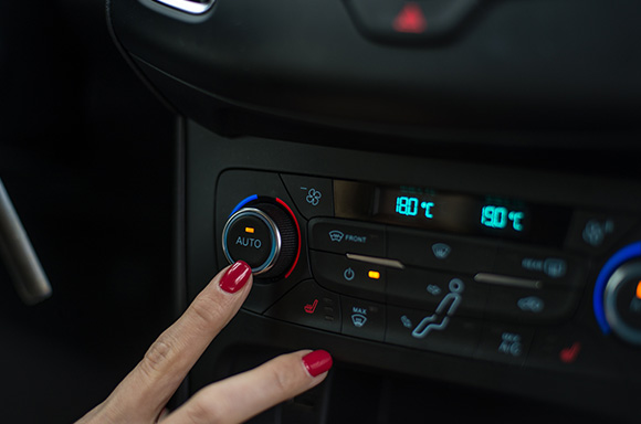 Car owner inspecting the air conditioning in their vehicle.