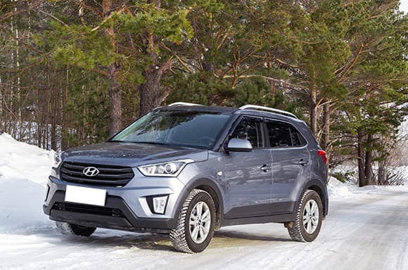 Image of a gray 2018 used Hyundai SUV parked on a winter road.