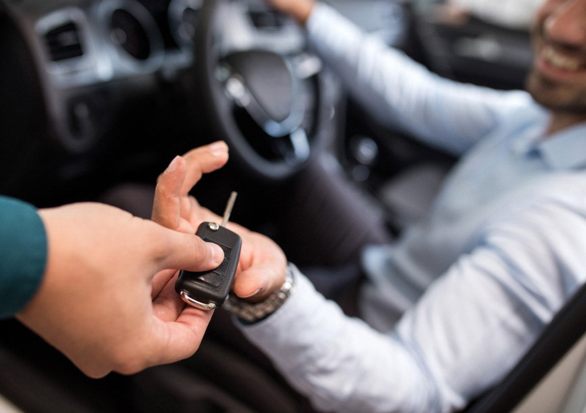 Sales person handing keys off to the customer.