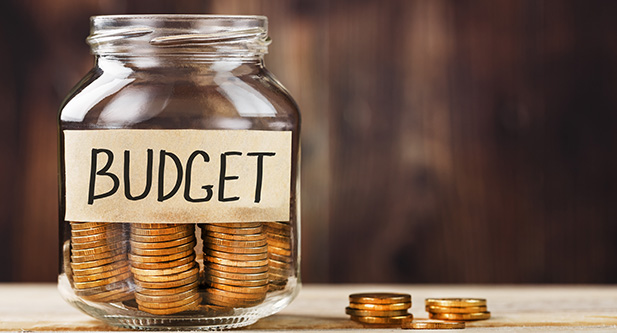 Image of a budget jar, with coins inside.