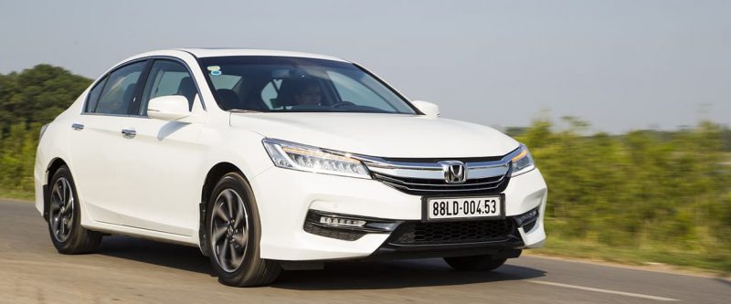 Image of a white Honda Accord, driving along the highway.