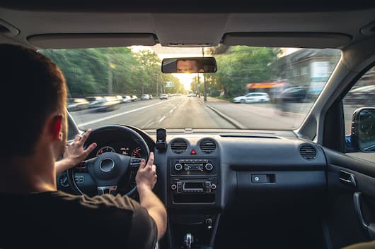 Image of a customer test driving a vehicle from RightRide, and testing for noise levels.