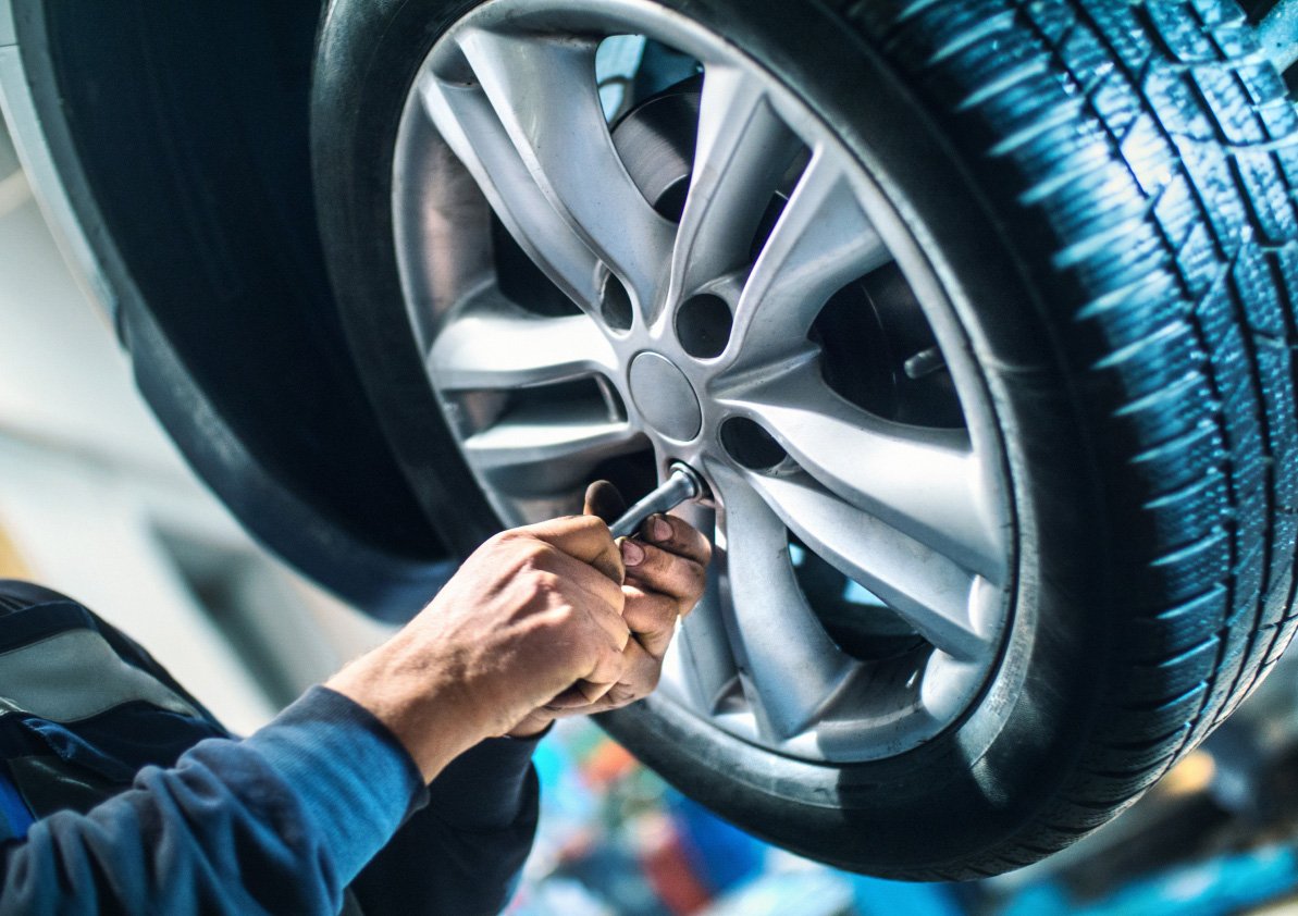 Mechanic removing a car tire.