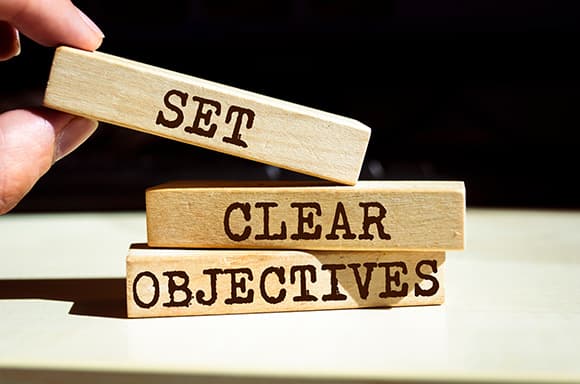 Image of a person stacking blocks, to deliver a messaging to set clear objectives to fix your finances.