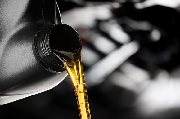 Image of engine oil being poured into the engine.