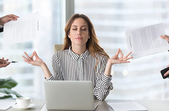 Image of a woman meditating, and staying Zen while facing bills and debt.