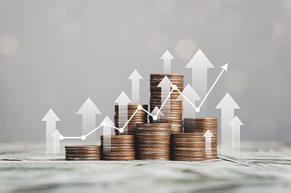 Image of a stack of coins and arrows pointing up, to symbolize growing your finances.