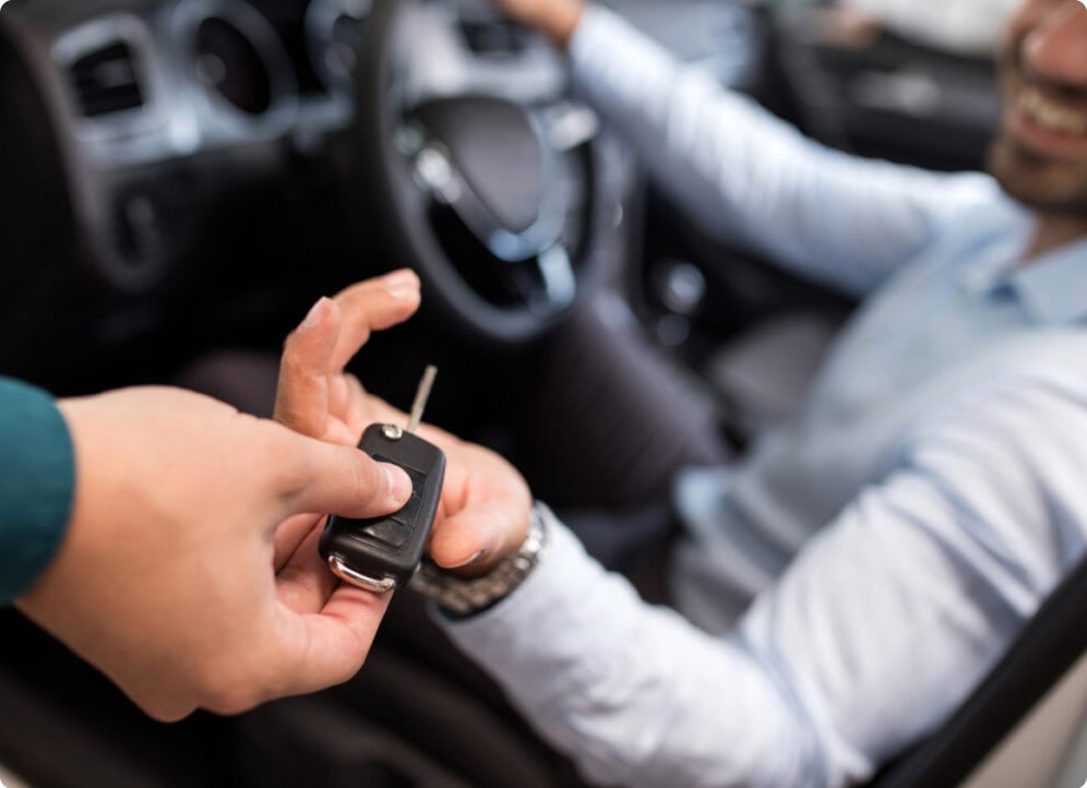 Sales person handing keys off to the customer.